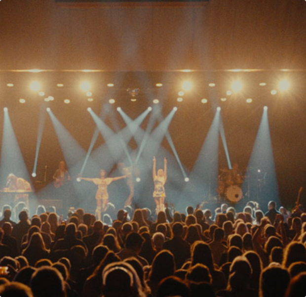 Audience enjoying a live concert at Wrest Point, featuring vibrant stage lighting and energetic performers.